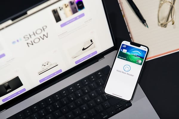 This image displays a laptop and smartphone on a table, showcasing an online shopping environment