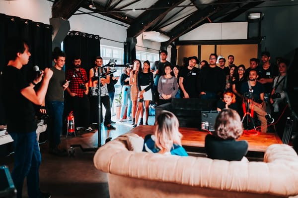 A group of people gathered in a spacious room for a presentation or workshop