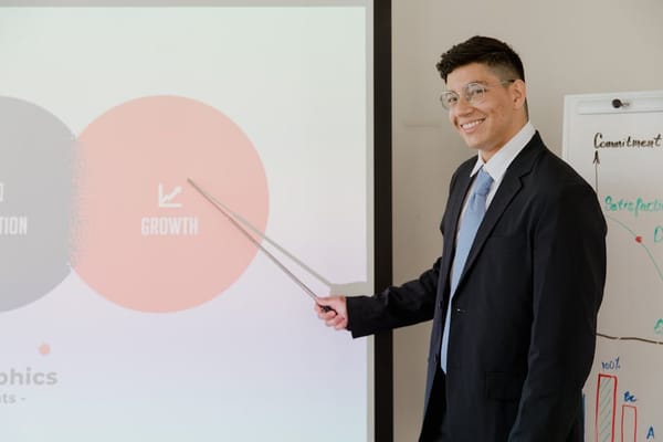 A man in a suit is giving a business presentation